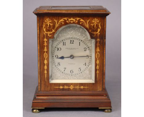 An Edwardian mantel clock in marquetry inlaid mahogany case with satinwood crossbanding &amp; ebonised stringing, the 3¾” eng
