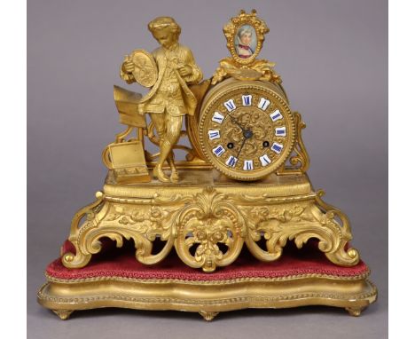 A late 19th century French gilt-speltre mantel clock with figural mounts depicting an artist &amp; his work, a painted porcel