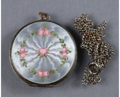 A continental white metal &amp; guilloche enamel flat round pendant locket painted with a garland of pink roses on a pearl-gr