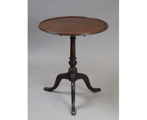 A Georgian mahogany tripod table, the circular tilt-top on a vase-turned centre column &amp; three cabriole legs with pad fee
