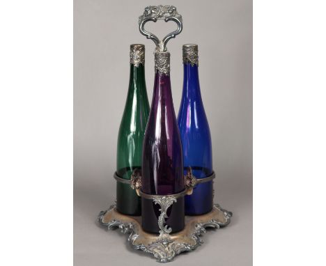 A set of three early Victorian coloured glass decanters with embossed plated grapevine mounts &amp; stoppers, an original She