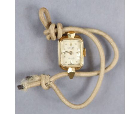 An 18k Rolex Precision ladies’ wristwatch, the rectangular white engine-turned dial with gold baton numerals, 17 jewel moveme