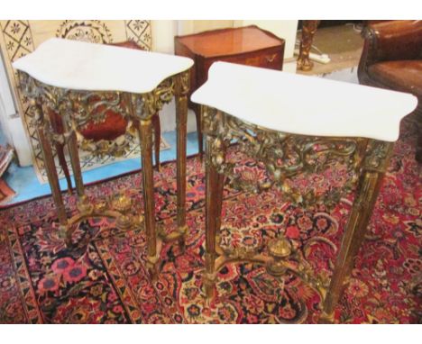 CONSOLE TABLES, a pair, Louis XV style gilt framed with serpentine shaped marble tops and floral, scroll and swag decoration 