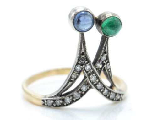 A 14ct gold emerald and sapphire diamond ring. The ring set with sapphire and emerald cabochons&nbsp; and channel set diamond