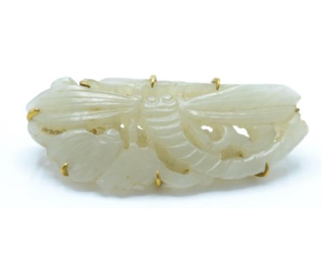 An antique Chinese jade 14ct gold large dragonfly brooch. The jade carved into a dragonfly with chased and pierced detailing.
