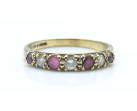 A hallmarked London 9ct gold ruby and diamond 7 stone ring.  Total weight 1.4g / Size K.5