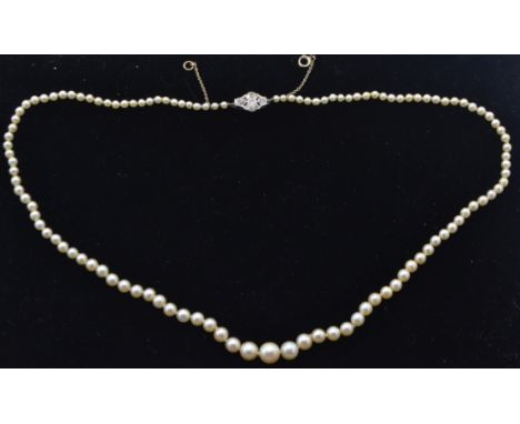 A cased pearl and diamond necklace. The single string of graduated pearls united by white metal and diamond clasp completed w
