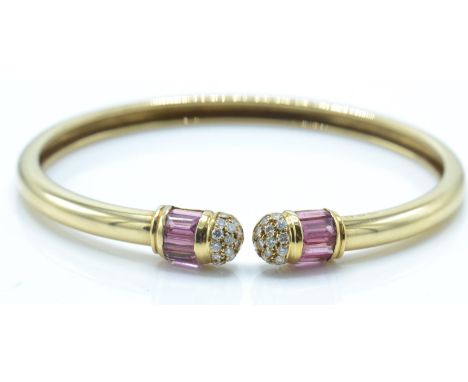 A hallmarked 18ct gold David Morris tourmaline and diamond bangle. The bangle set with round brilliant cut diamonds and pink 