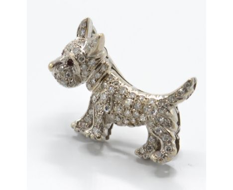 An 18ct white gold diamond and ruby figural brooch pin. The brooch in the form of a Highland Terrier / Scottie dog. Having an