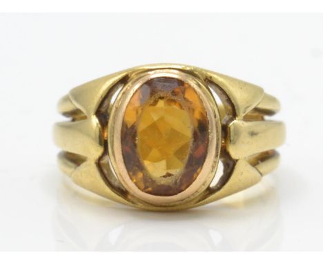 A French Art Nouveau 18ct gold and citrine ring. The ring set with an oval mixed cut citrine in a double bezel setting having