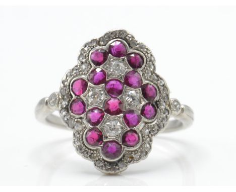 An antique Edwardian platinum, ruby and diamond ring. The ring set with round mixed cut old cut and rose cut diamonds within 