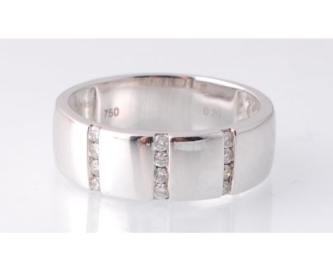 A hallmarked 18ct white gold and diamond band ring. The ring being set with three rows of diamonds in a wide band. Hallmarked