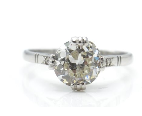 An 18ct white gold and diamond ring. The ring having a central round brilliant cut diamond set within a pierced gallery to di