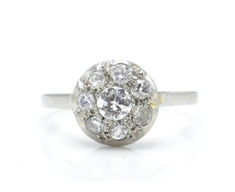 A platinum and diamond cluster ring. The ring having a central diamond of approx 0.25ct surrounded by diamonds of approx 0.5c