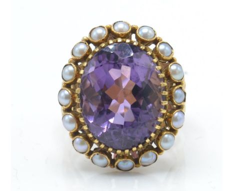 A 19th century French amethyst and pearl dress ring. The ring set with a large oval mixed cut amethyst within a prog setting,