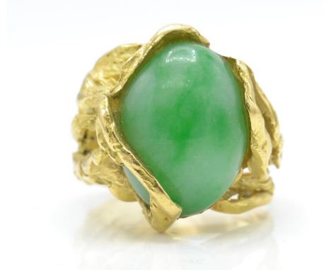A&nbsp; French 18ct gold wirework jade ring. The ring being formed in a wirework naturalistic design encasing a large Jade ca