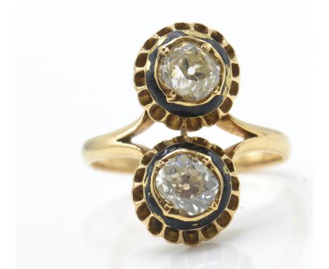 An 18ct gold enamel and diamond ring. The ring set with 2 old diamonds within a pierced bezel setting with black enamel borde