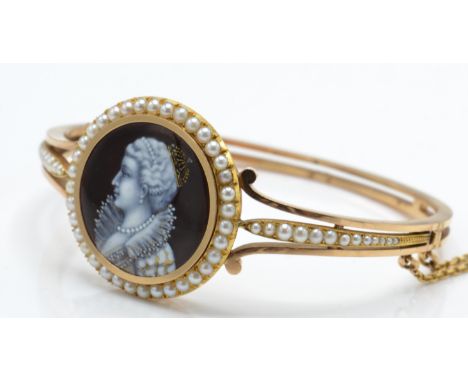An antique gold and seed pearl hinged bracelet /&nbsp; bangle. The bangle having an applied enamelled portrait - possibly Eli