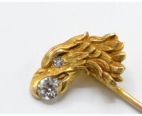 An 18ct gold and diamond figural eagle stick pin. The stick pin having an eagle head motif with diamond inset to beak and dia