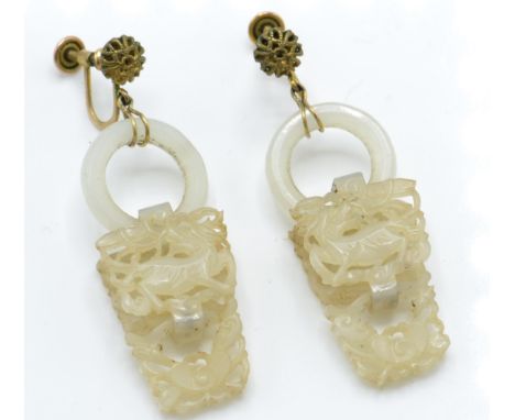 A pair of&nbsp; 19th century Chinese carved jade drop earrings. Each with gold screw posts having carved roundels with pierce