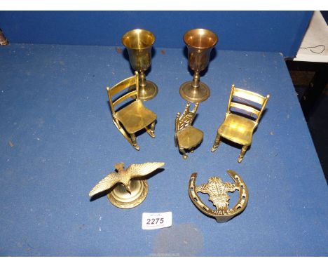 A quantity of brass including brass chairs, two goblets, a Wales door knocker and bird lid finial.