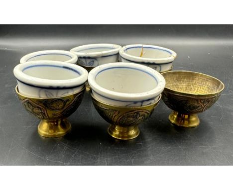 Six Chinese brass egg cups with blue and white ceramic liners AF