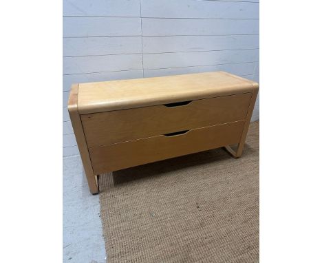 A contemporary light wood two drawer chest of drawers (H68cm W130cm D49cm)