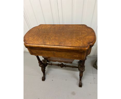 A Victorian Burr Walnut Games Table. The table top opens to reveal Chess, back gammon and cribbage below an inlaid drawer and