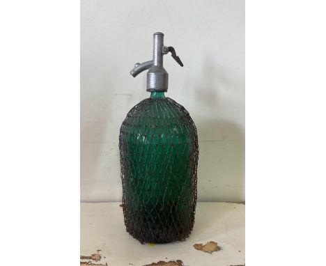 A vintage green glass soda siphon 