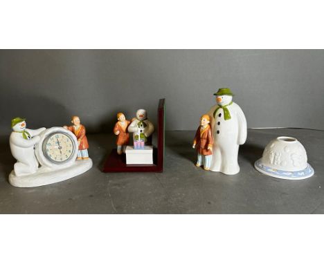 A selection of Coalport "The Snowman" collectables, a clock, bookend, moneybox and a tea light holder 