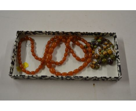 A light coloured amber type necklace; and another Scottish style necklace 