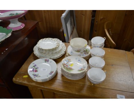 A quantity of tea cups and saucers with matching side plates decorated with hunting scenes; rose decorated plates etc. 