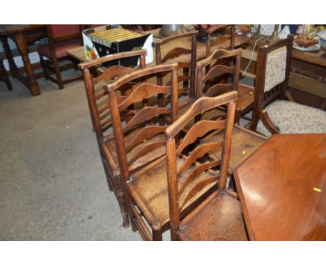 A set of six 19th Century elm seated ladder back chairs 
