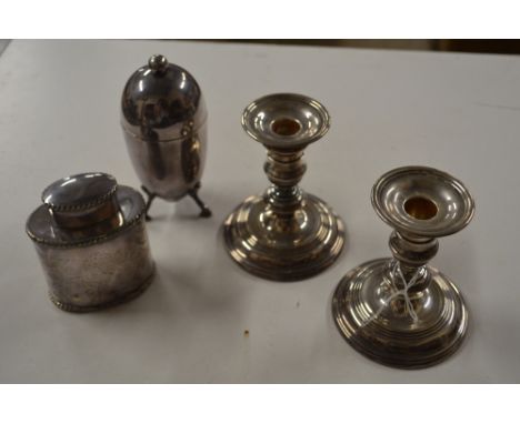 A pair of modern silver dwarf candlesticks, London 1972; a silver plated tea caddy; and an Elkington &amp; Co. plated coddler