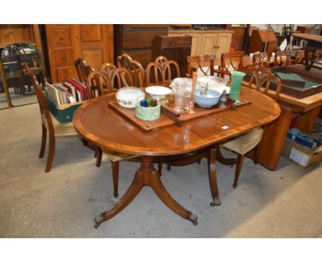 A Regency style twin pillar mahogany extending dining table with one extra leaf; together with a set of six Fleurs De Lys mah