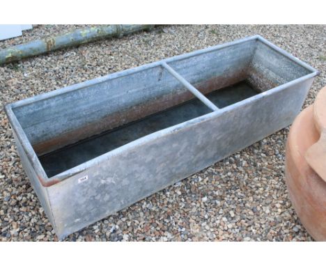 A large outdoor galvanised steel water trough, measures approx 154cm x 48cm x 40cm 