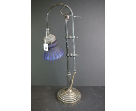 An early 20th century adjustable table lamp with blue glass shade. 