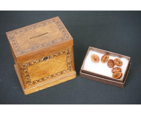 An antique wooden money box with inlay decoration together with Six Chinese Cherry Stone Carved Button Covers 