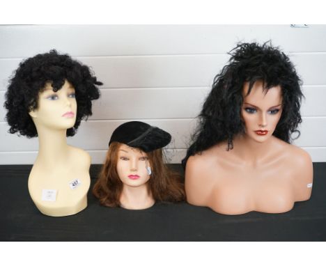 A collection of three contemporary shop display mannequin heads. 