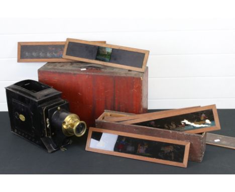 A antique magic lantern projector in original wooden box together with a small quantity of colour slides. 