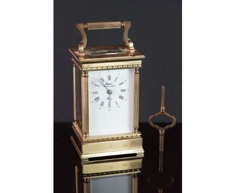 A French Rapport brass cased carriage clock with white enamel dial, complete with key. 