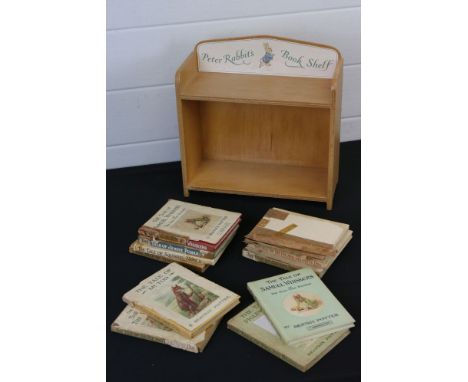 A collection of Beatrix Potter books together with a Peter Rabbit book shelf. 