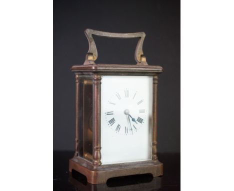 A French brass cased carriage clock with white enamel dial, complete with key. 