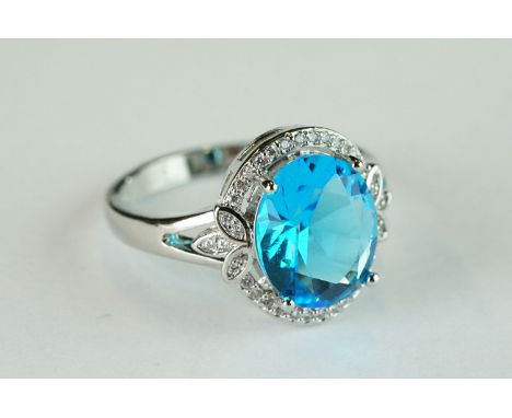 Silver and CZ Ring with central blue topaz style stone 