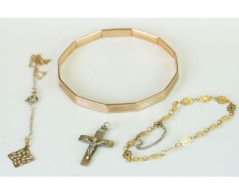 A 1970's 9ct gold metal core bangle bracelet together with a 9ct gold bracelet and two pendants. 
