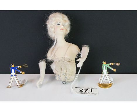 Two Art Deco enamel menu holders in the form of tennis players together with an antique doll. 