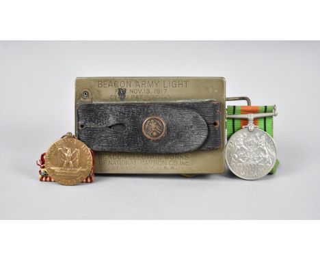 A World War II Defence Medal, an American Efficiency/Honor/Fidelity Good Conduct Medal and a Beacon Army Light Dated 1917