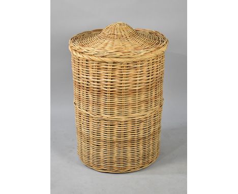 A Large Cylindrical Wicker Clothes Basket Together with a Ceramic Table Lamp, 52cm Diameter