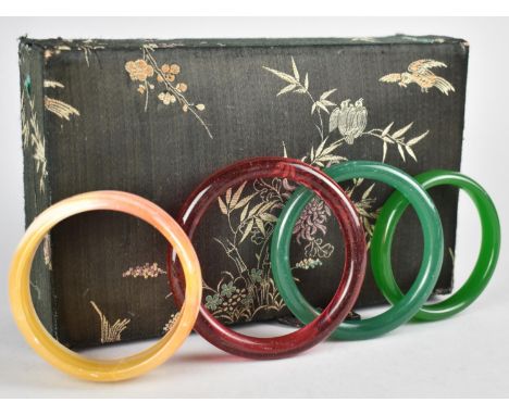 An Agate Bangle, together with Three Glass examples