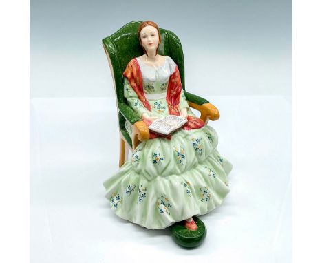 This figure depicts a Victorian woman in a green floral dress with a red scarf gracefully seated in her chair. The English La